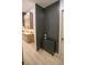 Hallway with stylish decor, including modern black paneled wall, cabinet with decor, and view into an open kitchen at 6713 Taneytown St, North Port, FL 34291