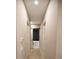 Neutral-toned hallway featuring access to a private bathroom with a tub and modern finishes at 6713 Taneytown St, North Port, FL 34291