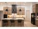 Modern kitchen featuring an island with countertop seating, a black refrigerator, and sleek, contemporary cabinetry at 6713 Taneytown St, North Port, FL 34291