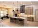 Open kitchen features a large island with countertop seating and pendant lighting, along with modern appliances and custom cabinets at 6713 Taneytown St, North Port, FL 34291