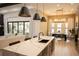Bright kitchen with large island overlooking living and dining areas and backyard patio at 6713 Taneytown St, North Port, FL 34291