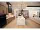 Open-concept kitchen with a large center island, modern appliances, custom cabinets, and seamless flow into the living area at 6713 Taneytown St, North Port, FL 34291