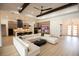 Open-concept living space with modern decor, beamed ceiling, and hardwood flooring at 6713 Taneytown St, North Port, FL 34291