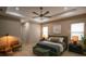 Bright and airy main bedroom with wood floors, seating area and neutral color palette at 6713 Taneytown St, North Port, FL 34291