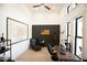 Bright office space featuring a ceiling fan, large windows, modern desk, and rustic wall decor at 6713 Taneytown St, North Port, FL 34291