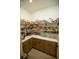 Walk-in pantry with ample shelving, custom cabinets, and countertop space for food storage and preparation at 6713 Taneytown St, North Port, FL 34291