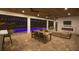 Beautifully designed outdoor patio with dining area, fireplace, and pool view at 6713 Taneytown St, North Port, FL 34291