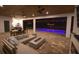 Inviting covered patio featuring modern furniture, a fireplace, and view of the pool at 6713 Taneytown St, North Port, FL 34291