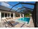 Stunning screened pool area with outdoor kitchen, dining, and multiple lounge spaces at 6713 Taneytown St, North Port, FL 34291