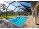 Relaxing screened pool with pavers, sunny skies, and adjacent hot tub for easy entertaining at 6713 Taneytown St, North Port, FL 34291