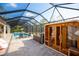 Relaxing screened pool area with sauna, lounge chairs, and stylish outdoor furniture at 6713 Taneytown St, North Port, FL 34291