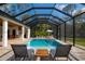 Beautiful pool with brick pavers, sun loungers, and a screened enclosure for year-round enjoyment at 6713 Taneytown St, North Port, FL 34291