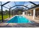 Sparkling swimming pool surrounded by a screened enclosure and brick pavers at 6713 Taneytown St, North Port, FL 34291
