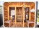 Inviting wooden sauna with glass door, bench seating, and a relaxing atmosphere at 6713 Taneytown St, North Port, FL 34291