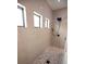 Modern bathroom shower with tiled walls and pebble floor at 6713 Taneytown St, North Port, FL 34291
