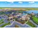 Aerial view of the community clubhouse and pool area with a lake and tennis courts at 6756 Chester Trl, Lakewood Ranch, FL 34202