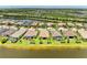 An aerial view showing a home in a picturesque neighborhood beside a lake at 6756 Chester Trl, Lakewood Ranch, FL 34202