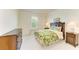 Well-lit bedroom with a tropical-themed bedspread and coordinating bedside tables and dresser at 6756 Chester Trl, Lakewood Ranch, FL 34202