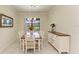 Dining room features a lake view, wood table, and white chairs at 6756 Chester Trl, Lakewood Ranch, FL 34202