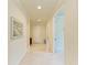 Bright foyer with neutral tile floors, white door, and elegant artwork at 6756 Chester Trl, Lakewood Ranch, FL 34202