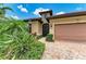 Close-up of a well-maintained home exterior showcasing a secure front door and lush landscaping at 6756 Chester Trl, Lakewood Ranch, FL 34202