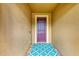 A close-up of a purple front door with a patterned welcome mat at 6756 Chester Trl, Lakewood Ranch, FL 34202