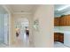 Hallway with arched doorway leading to an open-concept living area and kitchen at 6756 Chester Trl, Lakewood Ranch, FL 34202