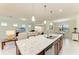 Bright kitchen with a granite countertop island, pendant lighting and stainless steel appliances at 6756 Chester Trl, Lakewood Ranch, FL 34202
