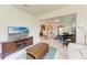 Open-concept living area with tile flooring, a tv, and clear sight-lines to the kitchen at 6756 Chester Trl, Lakewood Ranch, FL 34202