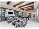 Inviting lounge with bookshelves, comfortable seating, a large table, and modern lighting at 6756 Chester Trl, Lakewood Ranch, FL 34202