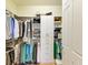 Well-organized walk-in closet with custom shelving and hanging rods, and carpet at 6756 Chester Trl, Lakewood Ranch, FL 34202