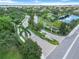 An aerial view showcases the manicured entrance and lush landscaping of this beautiful community at 7314 Hamilton Rd, Bradenton, FL 34209