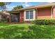 A well-maintained backyard featuring lush green grass, a screened lanai, and manicured landscaping at 7314 Hamilton Rd, Bradenton, FL 34209