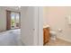 Well lit bathroom with tiled floors, toilet, and sink with brown wood cabinets at 7314 Hamilton Rd, Bradenton, FL 34209