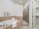 Bathroom with tiled tub, walk-in shower with glass door and large closet with shelving at 7314 Hamilton Rd, Bradenton, FL 34209