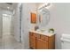 Bathroom vanity featuring a round mirror, neutral walls, tile floors and a toilet at 7314 Hamilton Rd, Bradenton, FL 34209