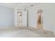 Spacious bedroom with neutral carpet and ceiling fan, leading to bathroom and closet at 7314 Hamilton Rd, Bradenton, FL 34209