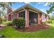 Exterior view of home featuring a screened in porch and lush landscaping at 7314 Hamilton Rd, Bradenton, FL 34209