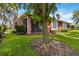Exterior home view showcasing lush lawn, landscaping, and a screened lanai at 7314 Hamilton Rd, Bradenton, FL 34209