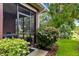Exterior view of the screened lanai and lush landscaping, adding to the home's appeal at 7314 Hamilton Rd, Bradenton, FL 34209