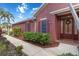Charming single-story home featuring a decorative wreath on the front door and manicured landscaping at 7314 Hamilton Rd, Bradenton, FL 34209