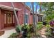 Home showcasing a covered entrance, lush landscaping with palm trees at 7314 Hamilton Rd, Bradenton, FL 34209