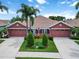 Charming home with landscaped front yard, a double driveway, and attached two-car garage offering curb appeal at 7314 Hamilton Rd, Bradenton, FL 34209