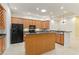 Open kitchen with bar seating, wood cabinetry, and modern appliances at 7314 Hamilton Rd, Bradenton, FL 34209