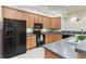 Well-equipped kitchen with black appliances, wood cabinets, and breakfast bar at 7314 Hamilton Rd, Bradenton, FL 34209