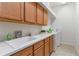 Spacious laundry room with sink, plenty of counter space, and washer and dryer hookups at 7314 Hamilton Rd, Bradenton, FL 34209