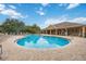 A luxurious community pool is surrounded by brick pavers and lounge chairs under a sunny sky at 7314 Hamilton Rd, Bradenton, FL 34209