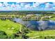 Scenic aerial view of the community showcasing beautiful lakes, lush landscaping, and well-maintained golf courses at 7911 Grand Estuary Trl # 102, Bradenton, FL 34212