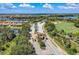 Aerial view of the community entrance, golf course, lakes, and surrounding homes at 7911 Grand Estuary Trl # 102, Bradenton, FL 34212