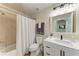 Well-lit bathroom with a shower-tub combo, vanity with a white countertop, and neutral finishes at 7911 Grand Estuary Trl # 102, Bradenton, FL 34212
